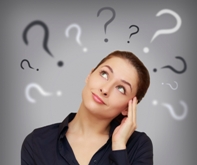 Beautiful business woman with question mark above the head looking up