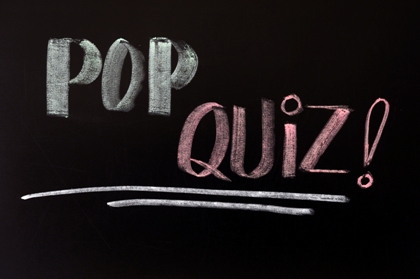 Pop quiz written in chalk on a blackboard